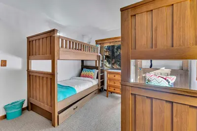 a bedroom with two bunk beds and a dresser at Northstar Retreat with Hot Tub & FREE Shuttle Access in Truckee