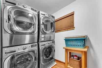 two washers and dryers in a laundry room at Northstar Retreat with Hot Tub & FREE Shuttle Access in Truckee