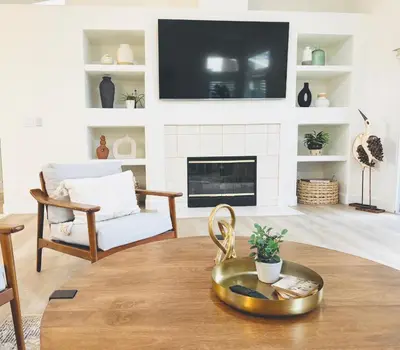 a living room with a fireplace and a tv at Charming Retreat in CA Valley in Fresno