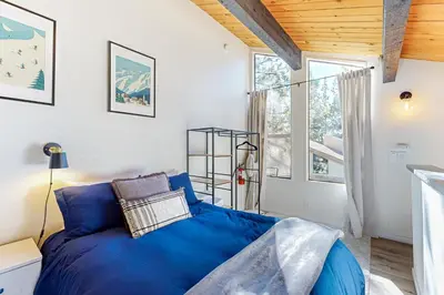 a bedroom with a blue bed and a window at Inn at South Lake Tahoe in Kings Beach