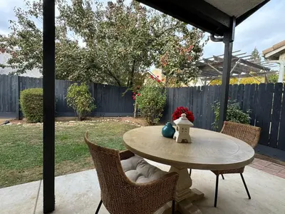 a patio table with chairs and a table with at Charming retreat in CA Valley in Fresno