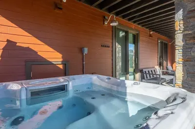 a hot tub on the side of a house at Creekhouse 1374 in Mammoth Lakes