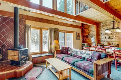 a living room with a couch and a stove at The Calder Cabin in Soda Springs