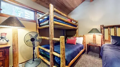 a bedroom with two bunk beds and a fan at Winterset #33 condo in Mammoth Lakes