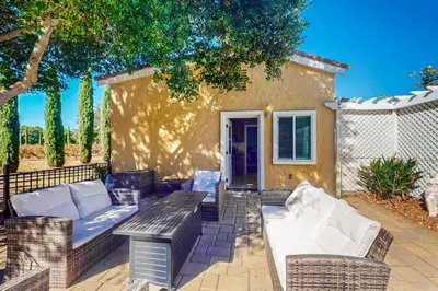 a patio with couches and a table and a fence at Morgan Hill Couples Gem Villa in the Vineyards in Morgan Hill
