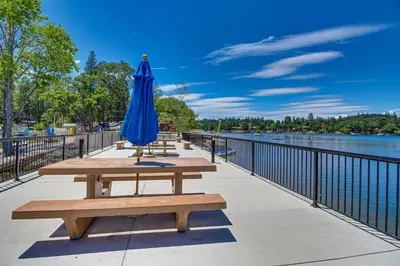 a blue umbrella sitting on a picnic table next to the water at Green Abode in Groveland