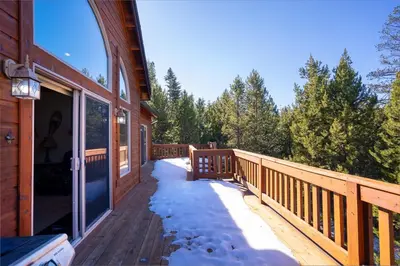 a deck on the side of a house with snow at Hillside Mountain Creek Haven home in Truckee