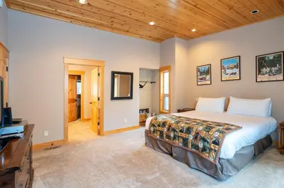 a bedroom with a bed and a flat screen tv at Hillside Mountain Creek Haven home in Truckee