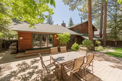 a patio with a table and chairs in front of a house at Serenity at Dollar Point - Luxurious 4BR w Private Backyard in Tahoe City