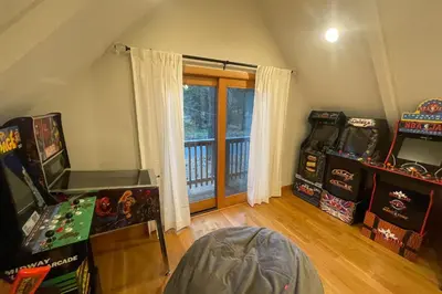 an attic room with arcade games and a window at Tahoe West Shore Escape in Tahoe City