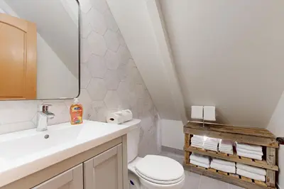 a bathroom with a sink and a toilet and a mirror at Tahoe West Shore Escape in Tahoe City