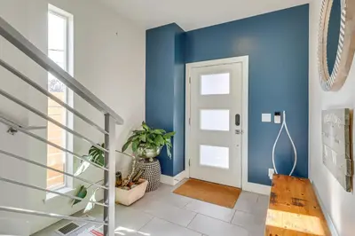 a hallway with blue walls and a door at Less Than 2 Mi to Dtwn Reno Luxe MidTown Gem with Patio in Reno
