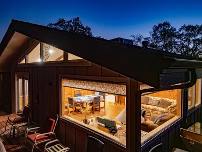 a view of a house with a large window at Yosemite Mountaintop Retreat on 100 acres, 2 Homes, 2 hot tubs, pool in Mariposa