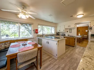 a kitchen and living room with a table and chairs at Yosemite Mountaintop Retreat on 100 acres, 2 Homes, 2 hot tubs, pool in Mariposa