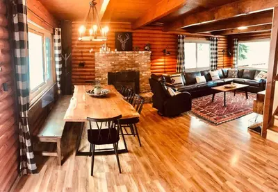 a living room with a table and a fireplace at Happy Cabin Near Snow and Lake with Hot Tub, Dogs OK in Tahoe Vista
