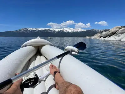 a man is on a boat in the water at Happy Cabin Near Snow and Lake with Hot Tub, Dogs OK in Tahoe Vista