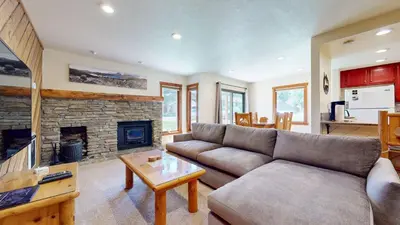 a living room with a couch and a fireplace at Snowcreek II #279 condo in Mammoth Lakes