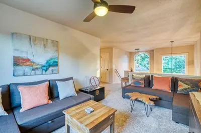 a living room with a blue couch and a table at Sunset Retreat AC, Big Views & Dream Deck in Shaver Lake