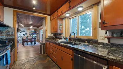 a kitchen with a sink and a counter top at Lakefront Haven by AvantStay Minutes to Ski Resorts Private Dock in Homewood