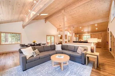 a living room with a couch and a table at Knotty and Nice - 4BR w Private Hot Tub, Close to Lake in Tahoe Vista