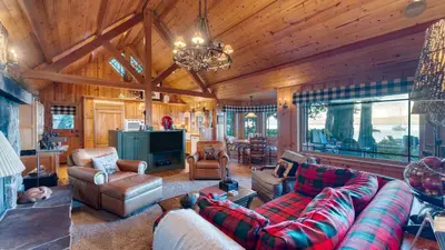 a large living room with a couch and chairs at Homewood Lakefront by AvantStay Private Beach Lake Access Views in Homewood