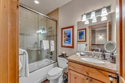 a bathroom with a tub and a toilet and a sink at Northstar Ski-In Ski-Out with Valley Views in Ponderosa Fairway Estates