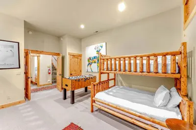 a bedroom with two bunk beds and a desk at Northstar Ski-In Ski-Out with Valley Views in Ponderosa Fairway Estates