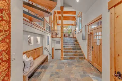 a hallway with stairs in a house with wooden ceilings at Northstar Ski-In Ski-Out with Valley Views in Ponderosa Fairway Estates
