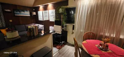 a dining room with a red table and a living room at Secret Oasis in Sacramento! in Sacramento
