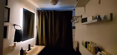 a bathroom with a sink and a mirror and a window at Secret Oasis in Sacramento! in Sacramento