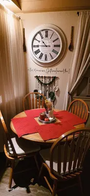 a dining room table with a clock on the wall at Secret Oasis in Sacramento! in Sacramento