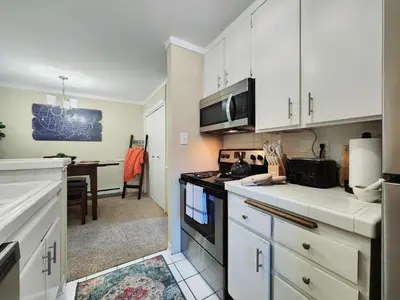 a kitchen with white cabinets and a stove top oven at Tahoe Shoreline Retreat - Close to Ski Resorts & HOA Amenities in Tahoe Vista