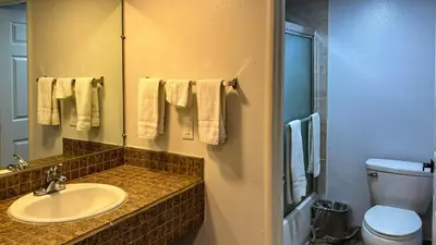 a bathroom with a sink and a toilet and a mirror at Motel 6 Selma, CA in Selma