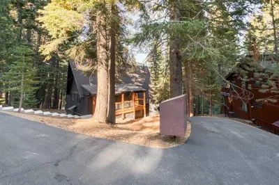 a house in the middle of a forest at A-Frame of Mind in Tahoe Donner - Pet-Friendly 2 BR 1 BA with Pool Table in Truckee