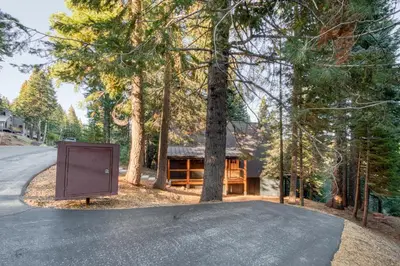 a house with a sign in the middle of a road at A-Frame of Mind in Tahoe Donner - Pet-Friendly 2 BR 1 BA with Pool Table in Truckee