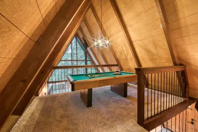 a room with a pool table in the attic at A-Frame of Mind in Tahoe Donner - Pet-Friendly 2 BR 1 BA with Pool Table in Truckee