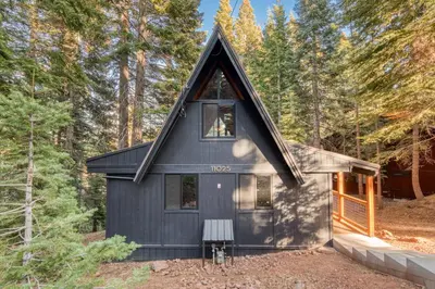 a black tiny house in the woods at A-Frame of Mind in Tahoe Donner - Pet-Friendly 2 BR 1 BA with Pool Table in Truckee