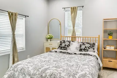 a bedroom with a bed and a mirror at Small-Town Charm and Patio Dining Home in Madera! in Madera
