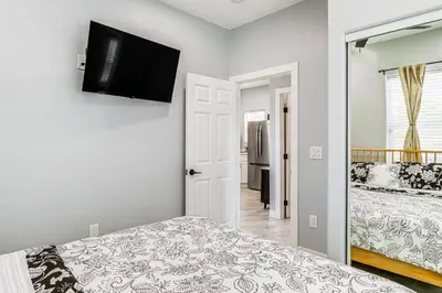 a bedroom with a bed and a flat screen tv at Small-Town Charm and Patio Dining Home in Madera! in Madera