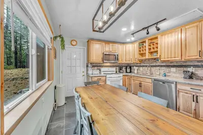 a kitchen with a wooden table and a counter top at Tahoe City Retreat Forest Views and Fireplace in Tahoe City