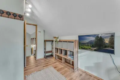a room with a bath tub and a balcony at Tahoe City Retreat Forest Views and Fireplace in Tahoe City