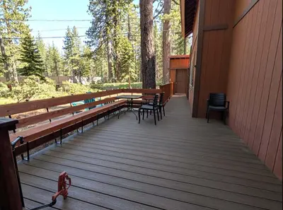 a wooden deck with benches and tables and chairs at Tahoe City Retreat Forest Views and Fireplace in Tahoe City