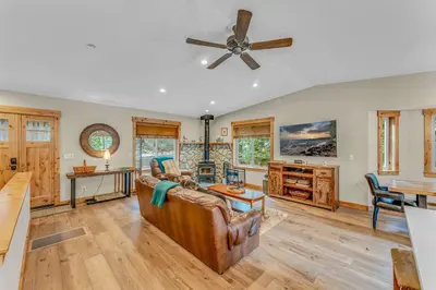 a living room with a couch and a ceiling fan at Tahoe Retreat with Scenic Views and Spacious Deck in Tahoe Vista