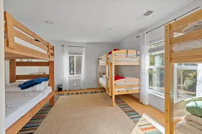 a room with two bunk beds and a window at Zen Whisper in the Woods in Groveland