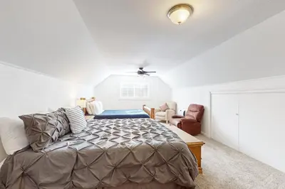 a bedroom with a bed and a chair at Lipan Lodge in South Lake Tahoe