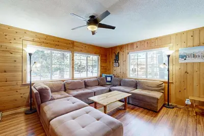 a living room with a couch and a ceiling fan at Lipan Lodge in South Lake Tahoe