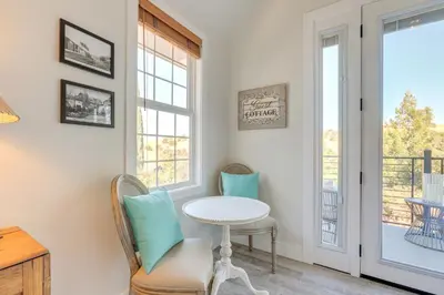 a table and chairs in a room with a window at Steps to Sutter Creek Chic Wine Country Cottage in Sutter Creek