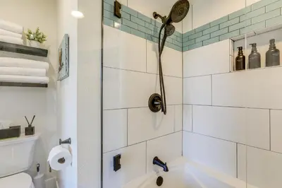 a bathroom with a shower and a toilet at Steps to Sutter Creek Chic Wine Country Cottage in Sutter Creek