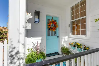 a front porch with a blue door and plants at Steps to Sutter Creek Chic Wine Country Cottage in Sutter Creek