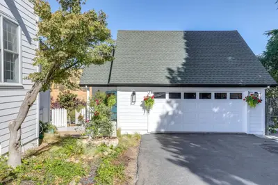 a white garage door with flowers on it at Steps to Sutter Creek Chic Wine Country Cottage in Sutter Creek